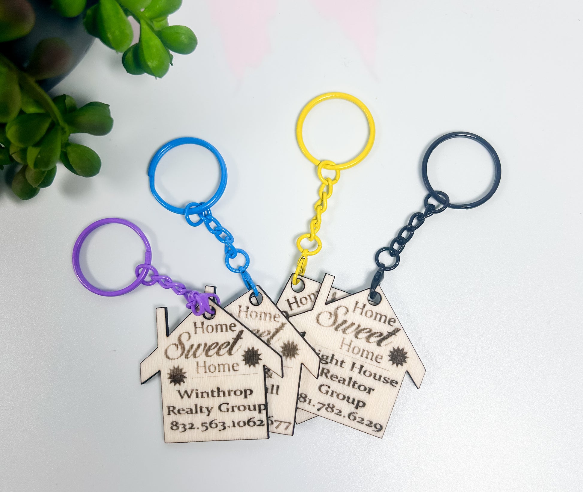 Three keychains with 'Home Sweet Home' tags on a white background