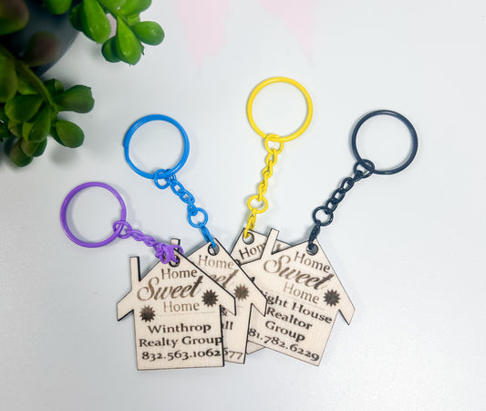 Three keychains with 'Home Sweet Home' tags on a white background