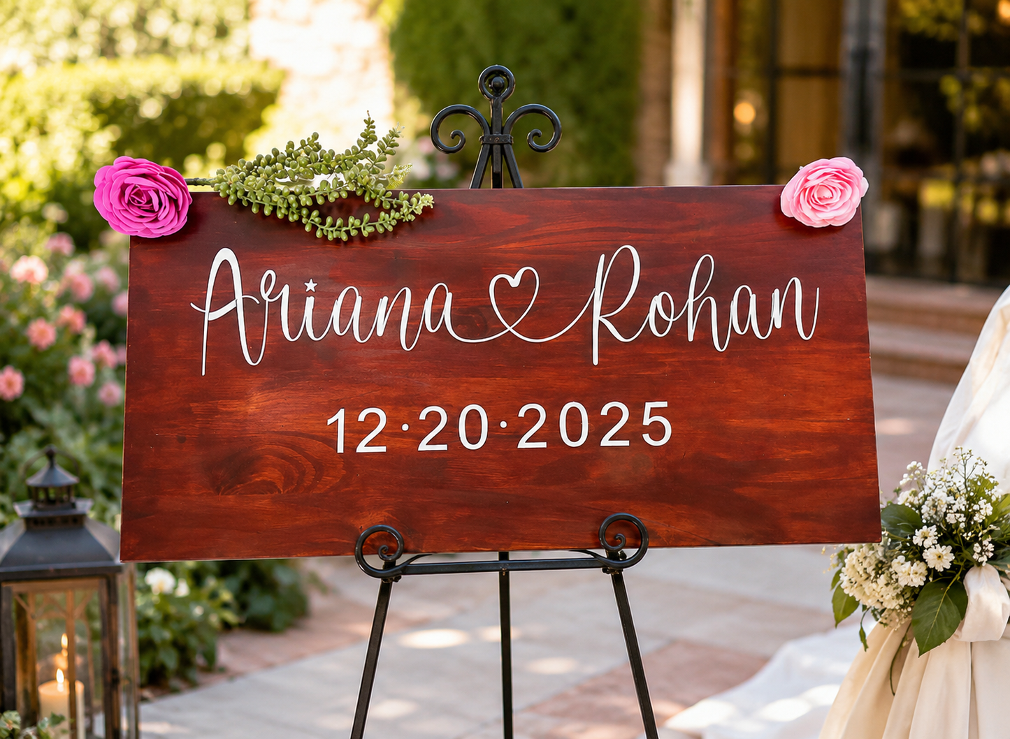 Custom wedding sign with engraved couple names and date, framed by an elegant flower garland and displayed outdoors. Personalized wedding entrance decor for rustic, boho, and garden weddings.